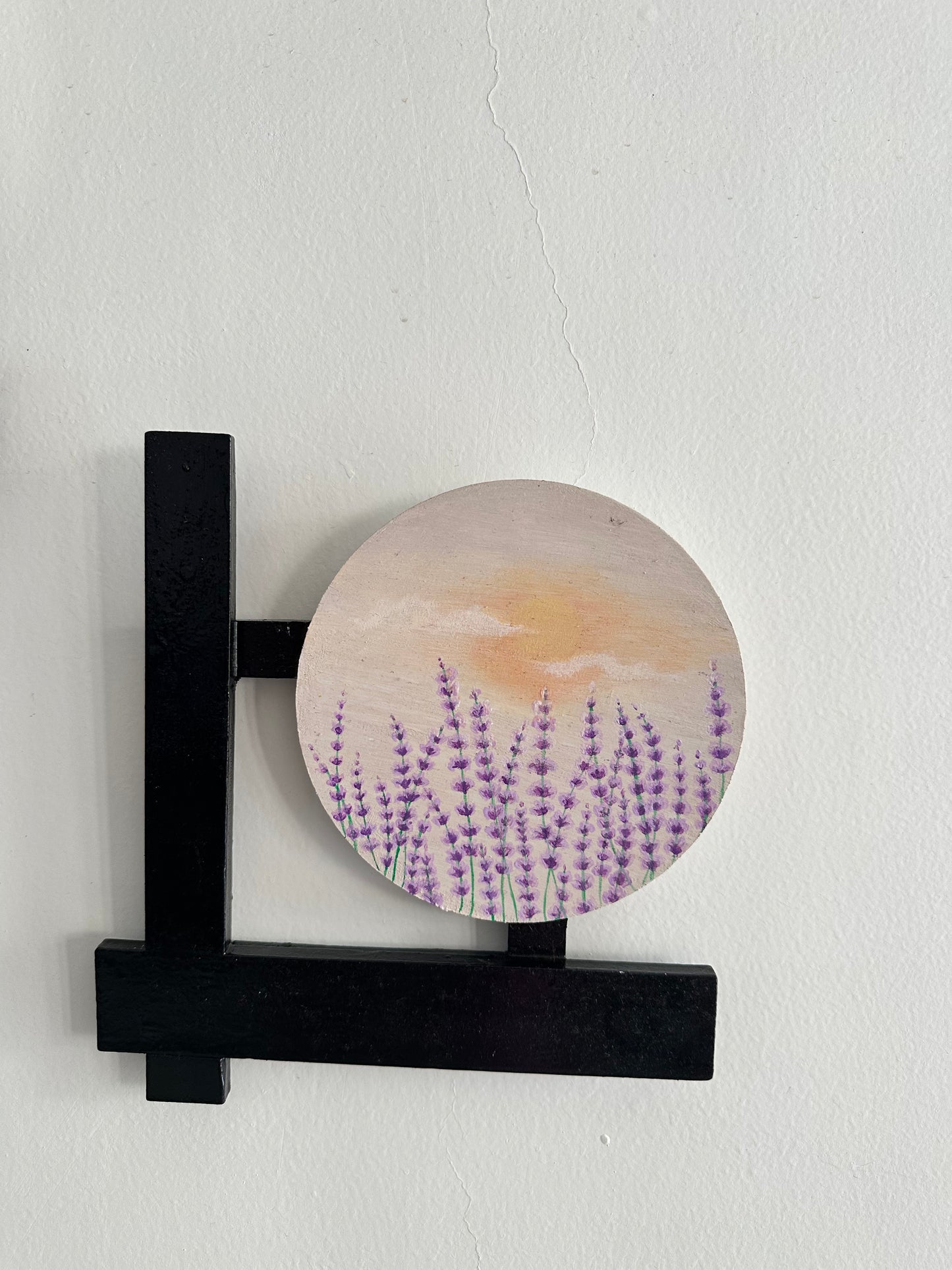 Set of 3 Floral wall hangings: Paintings on round MDF boards with black wooden L-shaped frames.