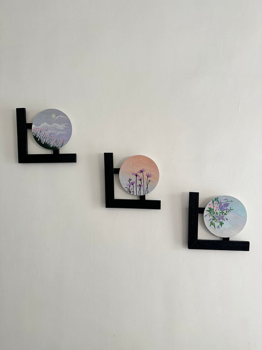 Wall hangings - set of 3 | Round Floral paintings with L-shaped black wooden frames.