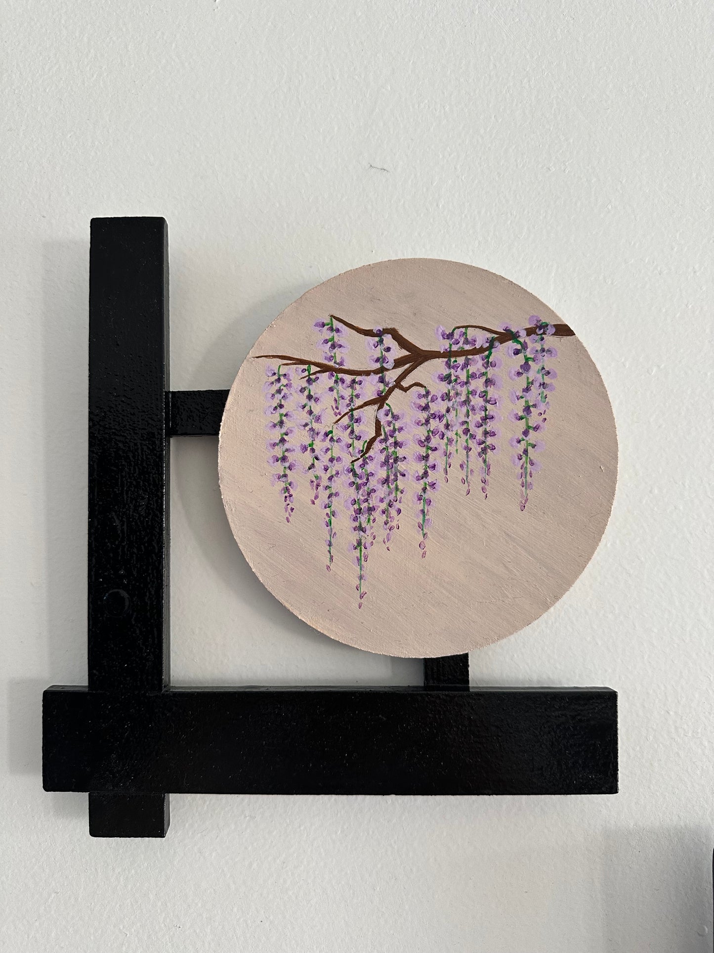 Set of 3 Floral wall hangings: Paintings on round MDF boards with black wooden L-shaped frames.