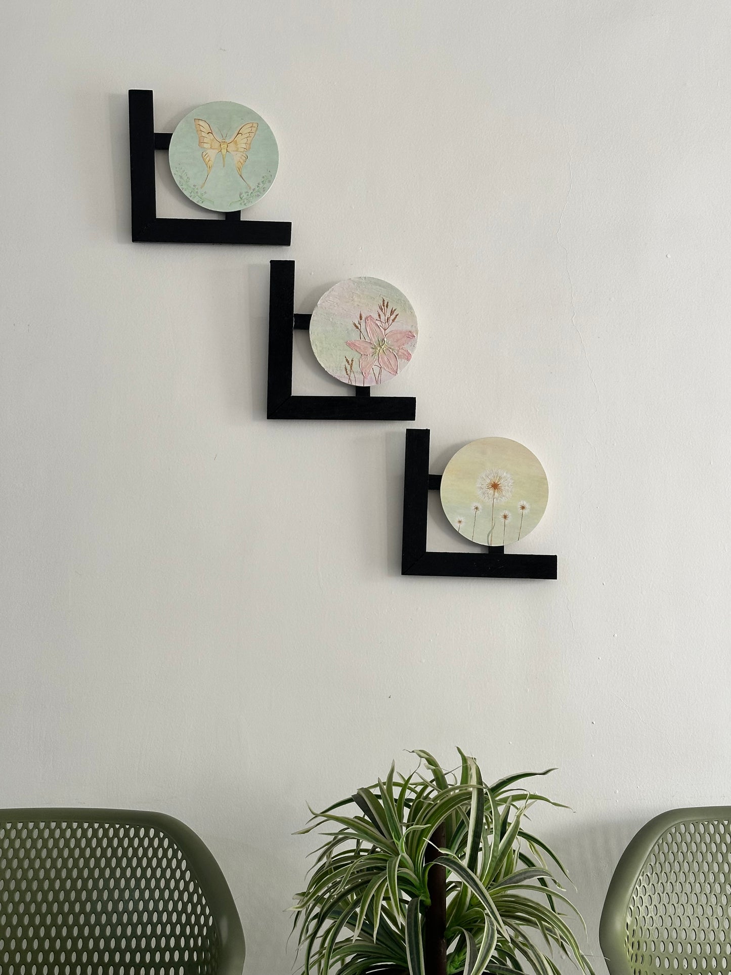 Set of 3 Floral wall hangings: Flat and Embossed Paintings on round MDF boards with black wooden L-shaped frames.
