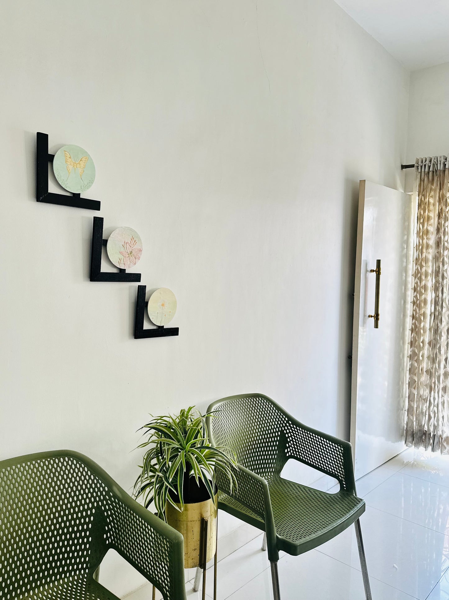 Set of 3 Floral wall hangings: Flat and Embossed Paintings on round MDF boards with black wooden L-shaped frames.